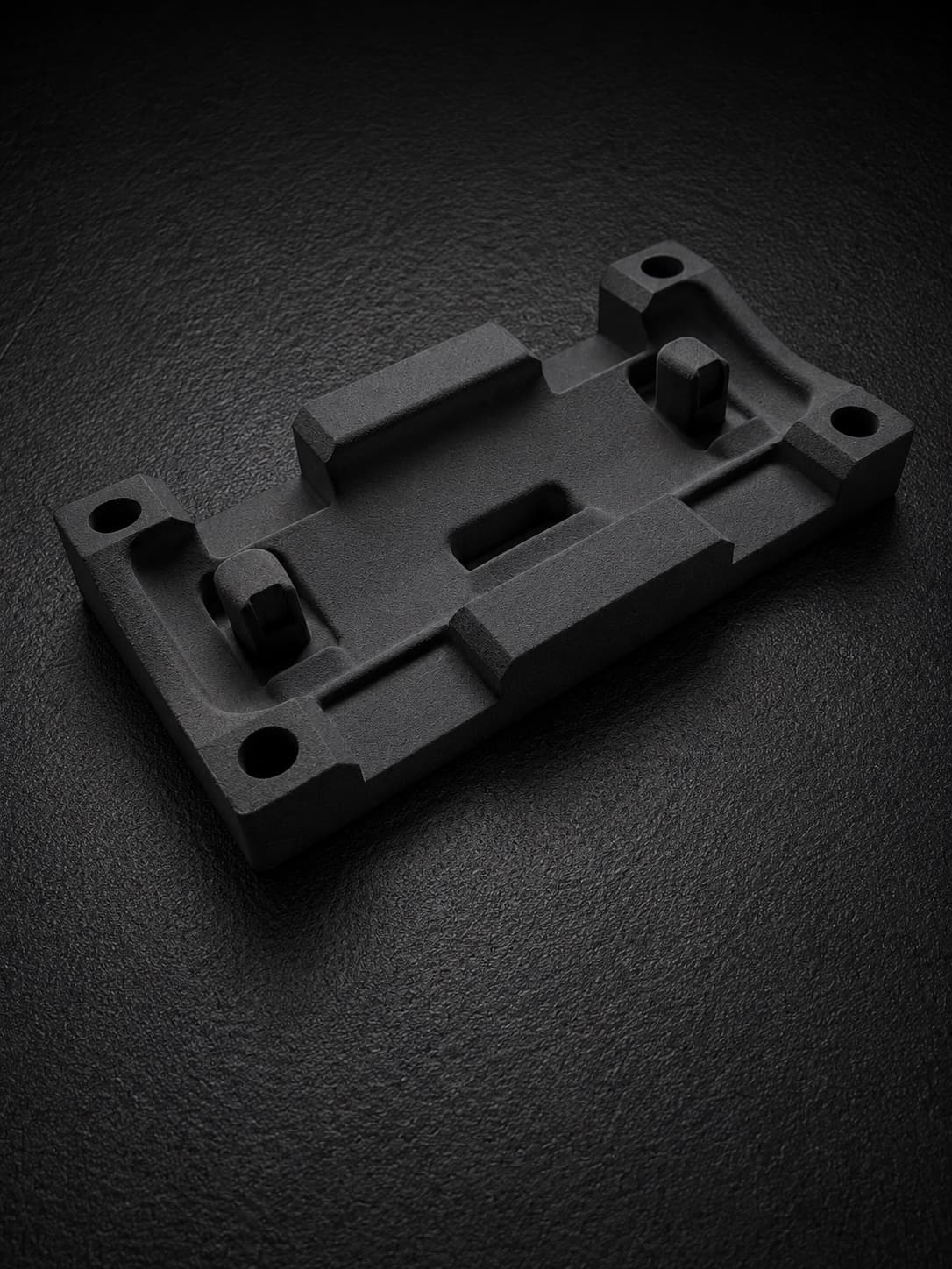 An SLS-printed TPU 90A fixture base plate with raised bosses and corner through-holes